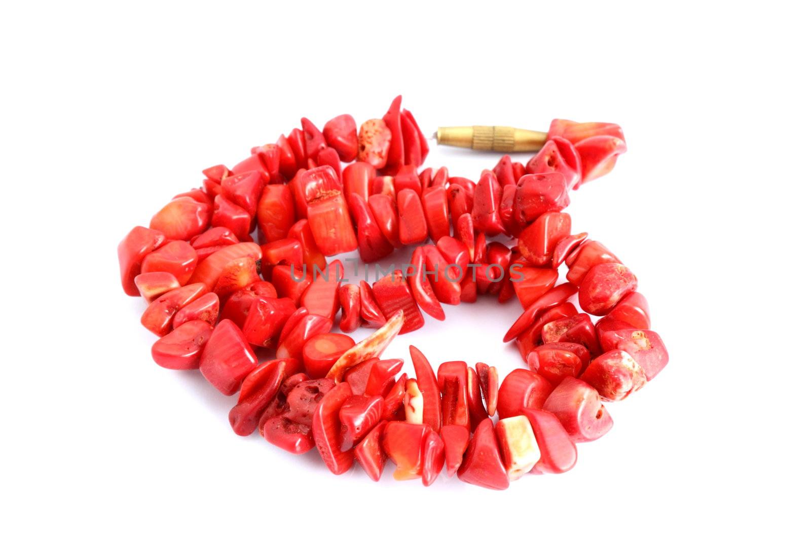 red coral beads over white background