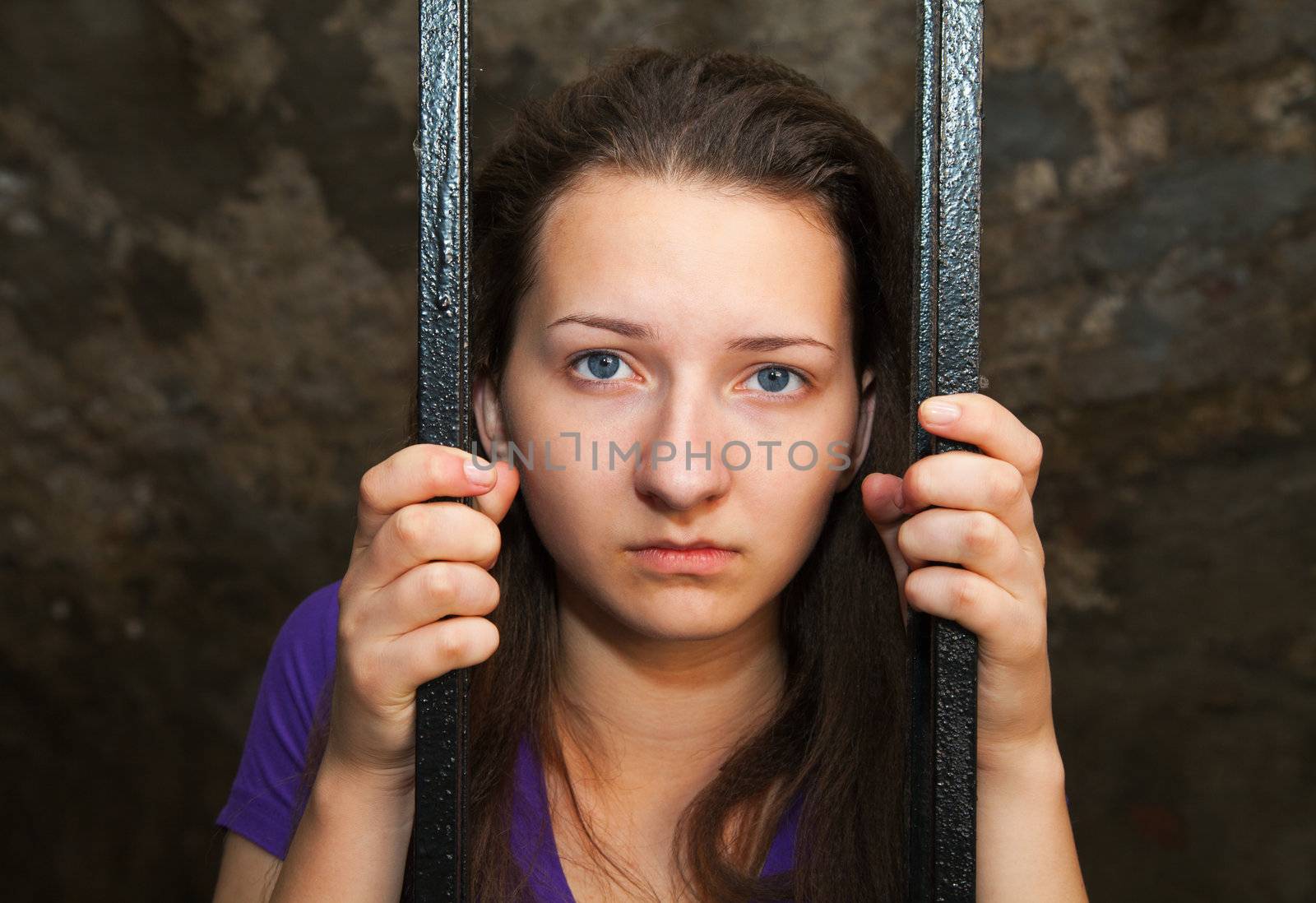 Young woman behind the bars by AndreyKr