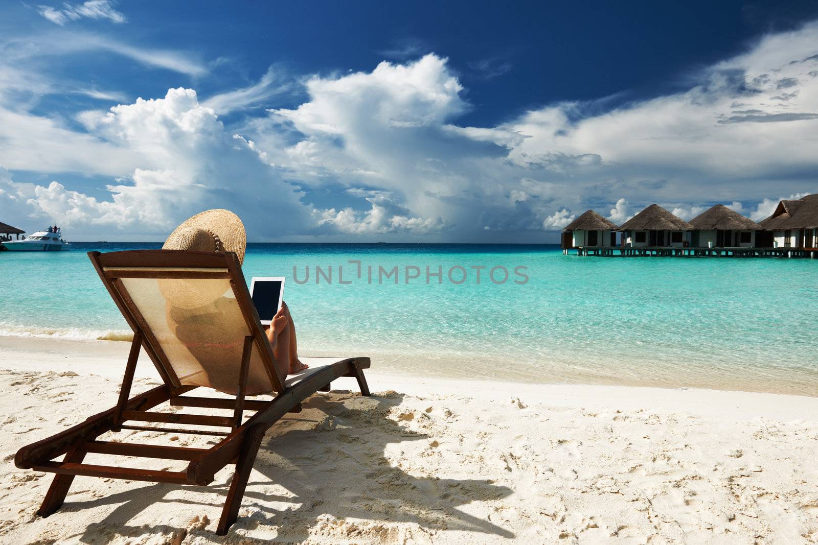 Young woman with tablet pc at the beach by haveseen
