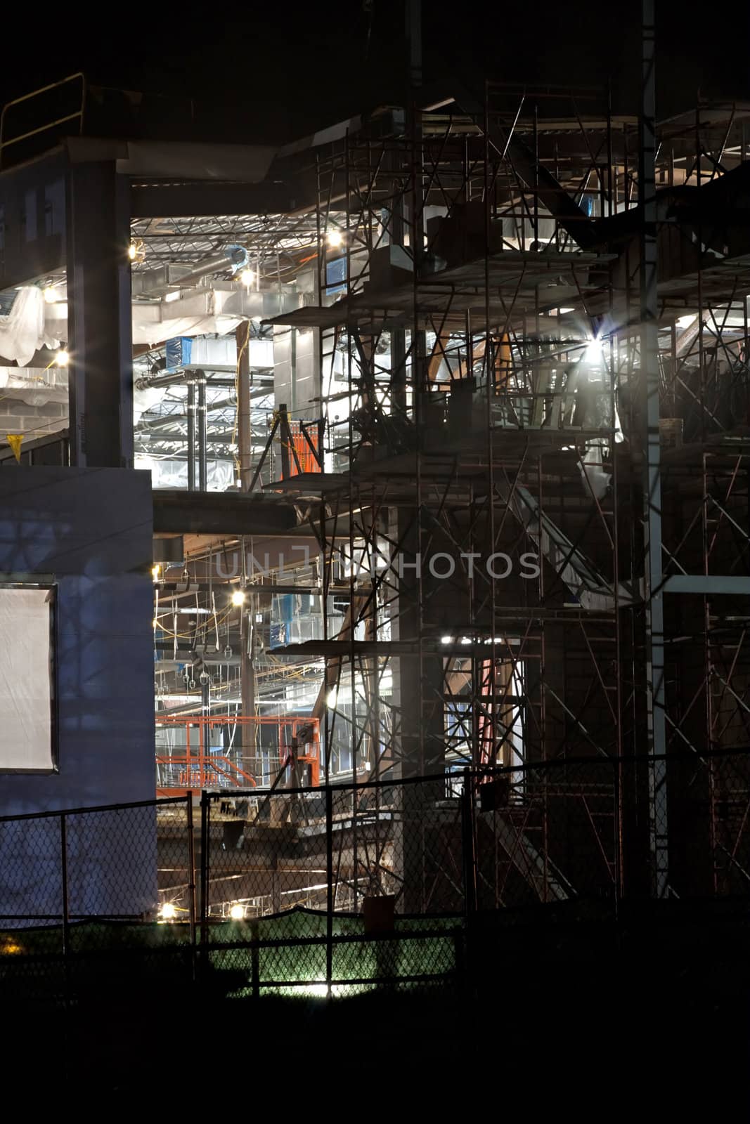 Unfinished building lit up at night for evening contruction.