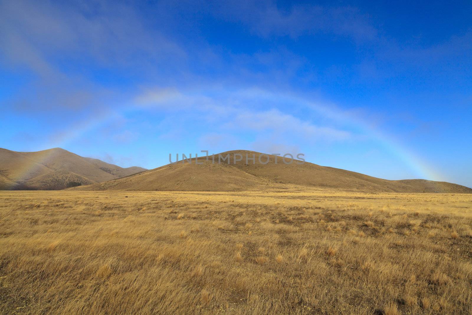 rainbow bridge over the dry grassland at the south island of new zealand