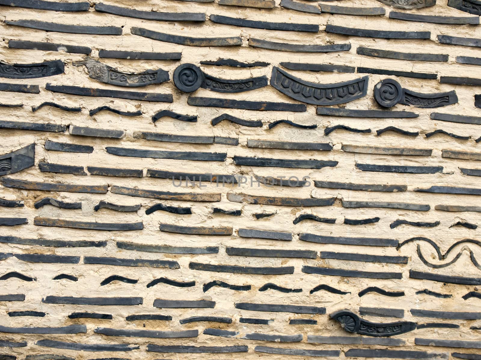 Old brick and Japanese roof tile in the wall