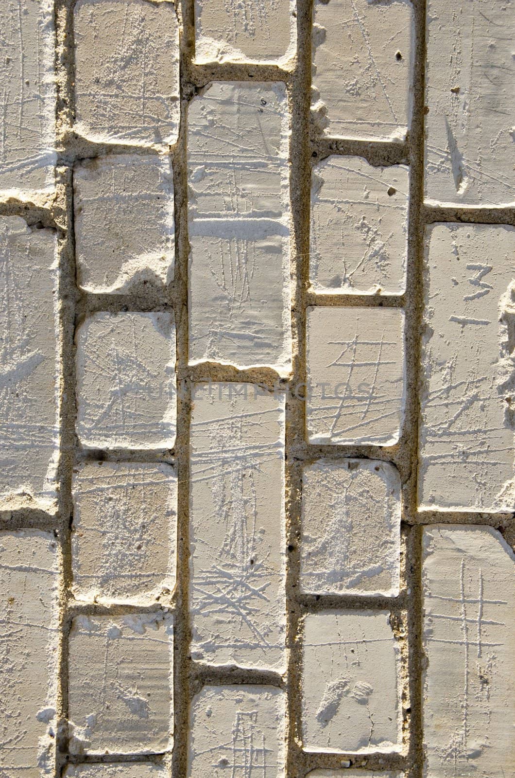 Wall made of white brick closeup detail background sunlighted by sun.