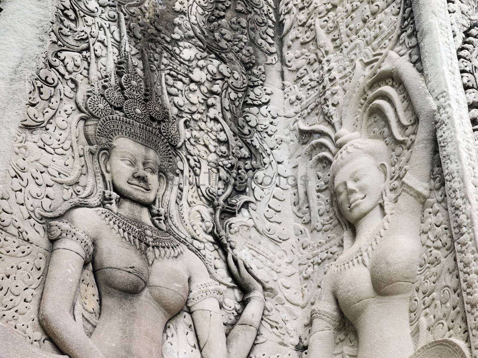 Details of sandstone carving of dancing Apsara on the wall of Angkor wat