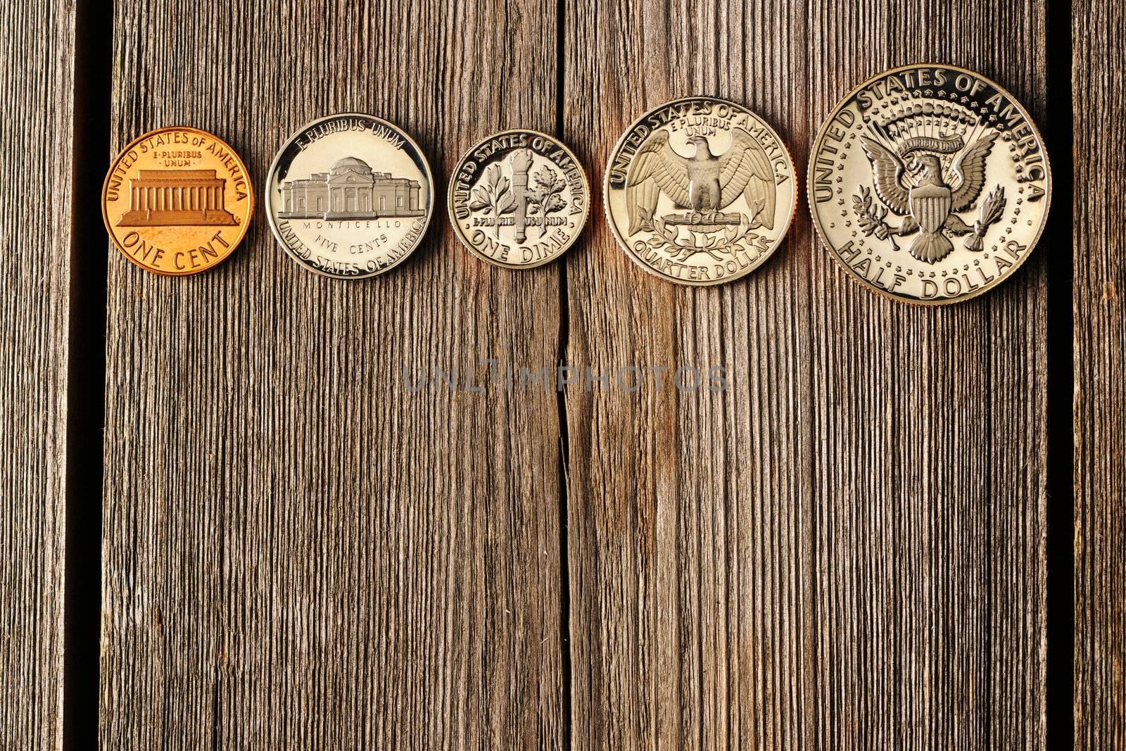Five US cent coins over wooden background