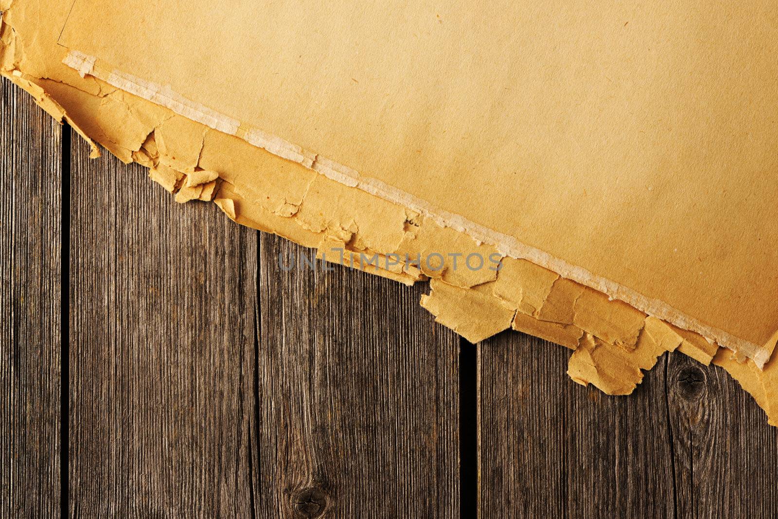 Old torn paper on wood planks background