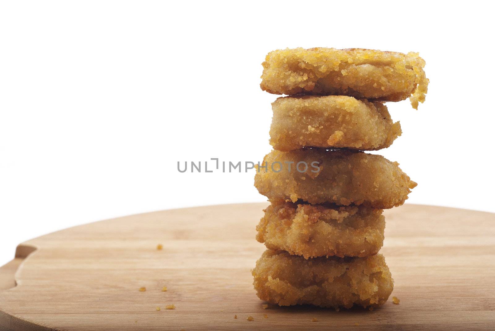 stack of fried chicken nuggets on wooden desk