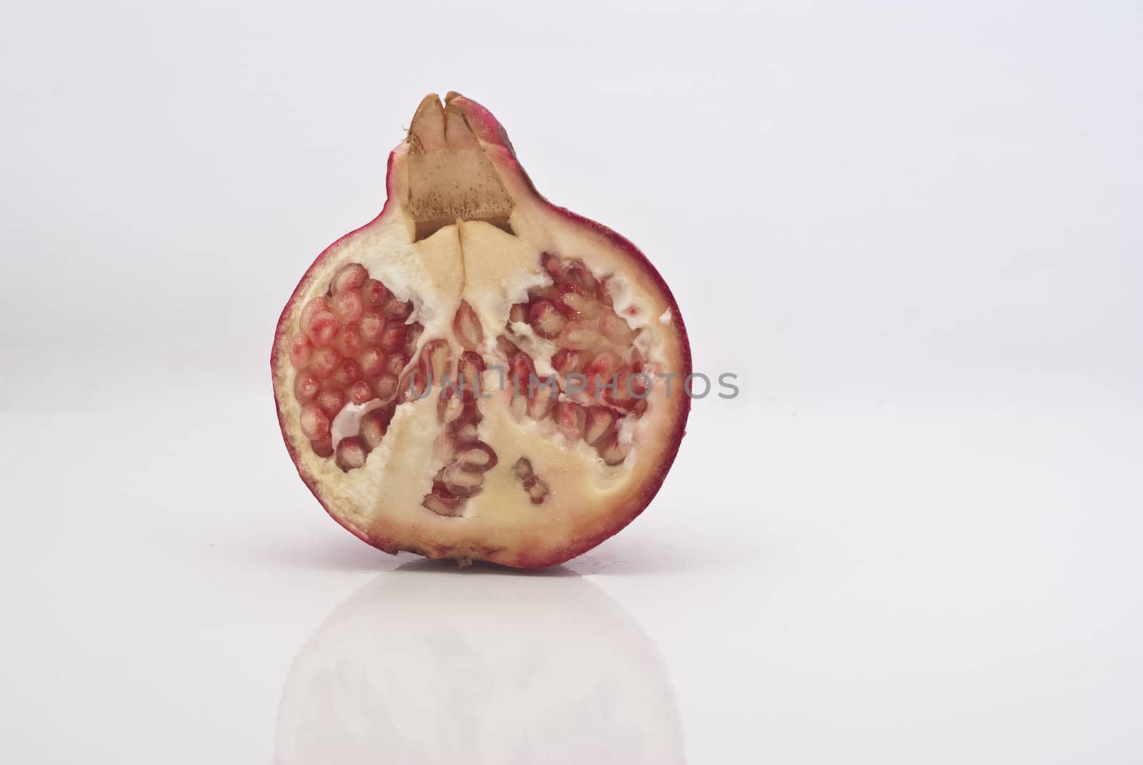 Ripe pomegranate fruit isolated on white background