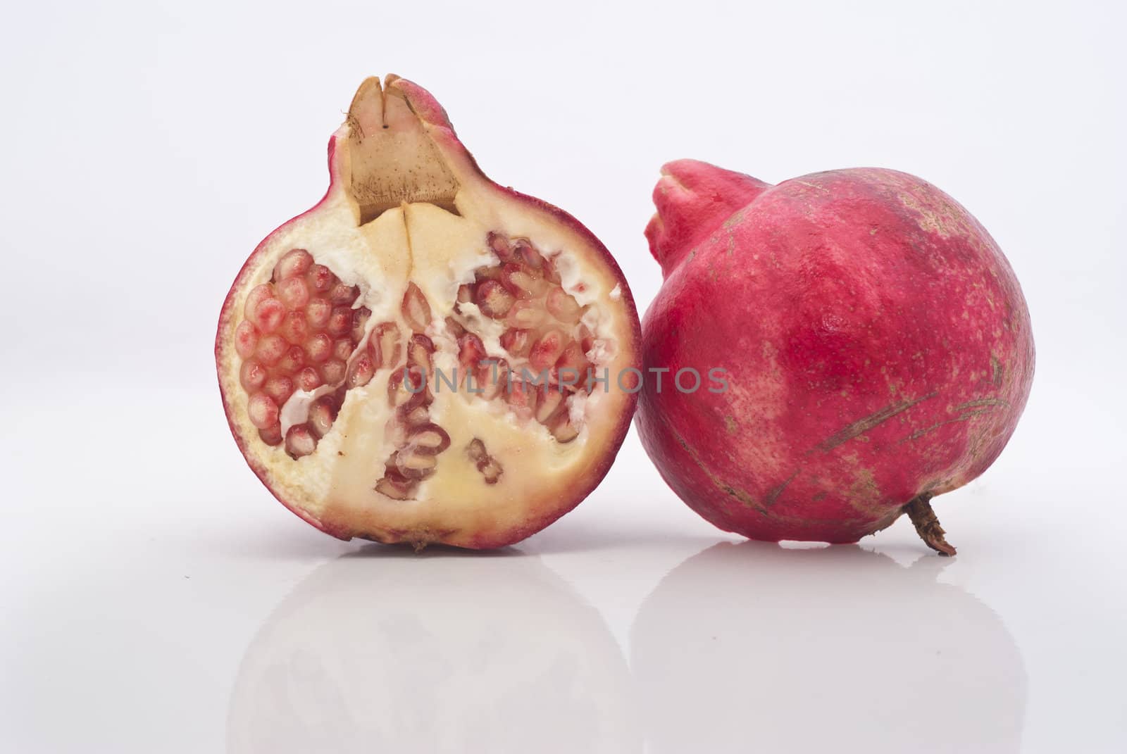 Ripe pomegranate fruit isolated on white background