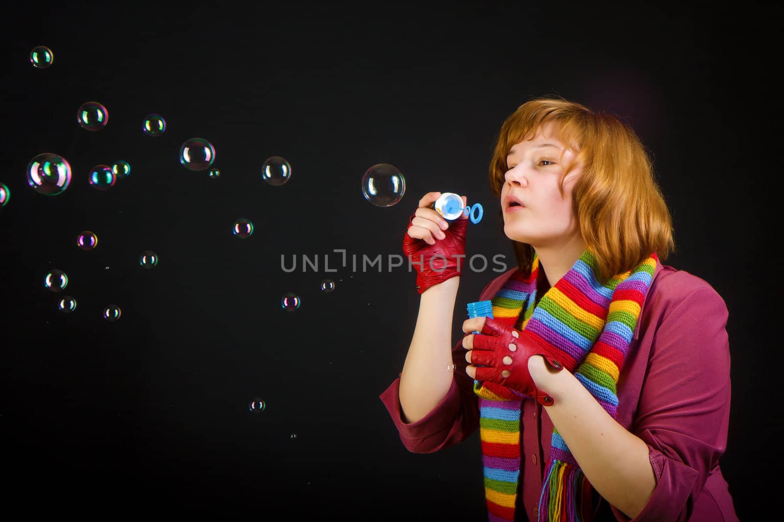 girl with soap bubbles on a black background
