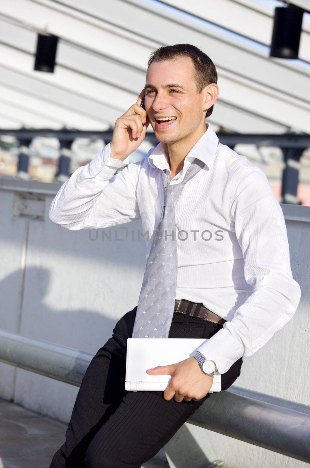 picture of businessman with cell phone and laptop