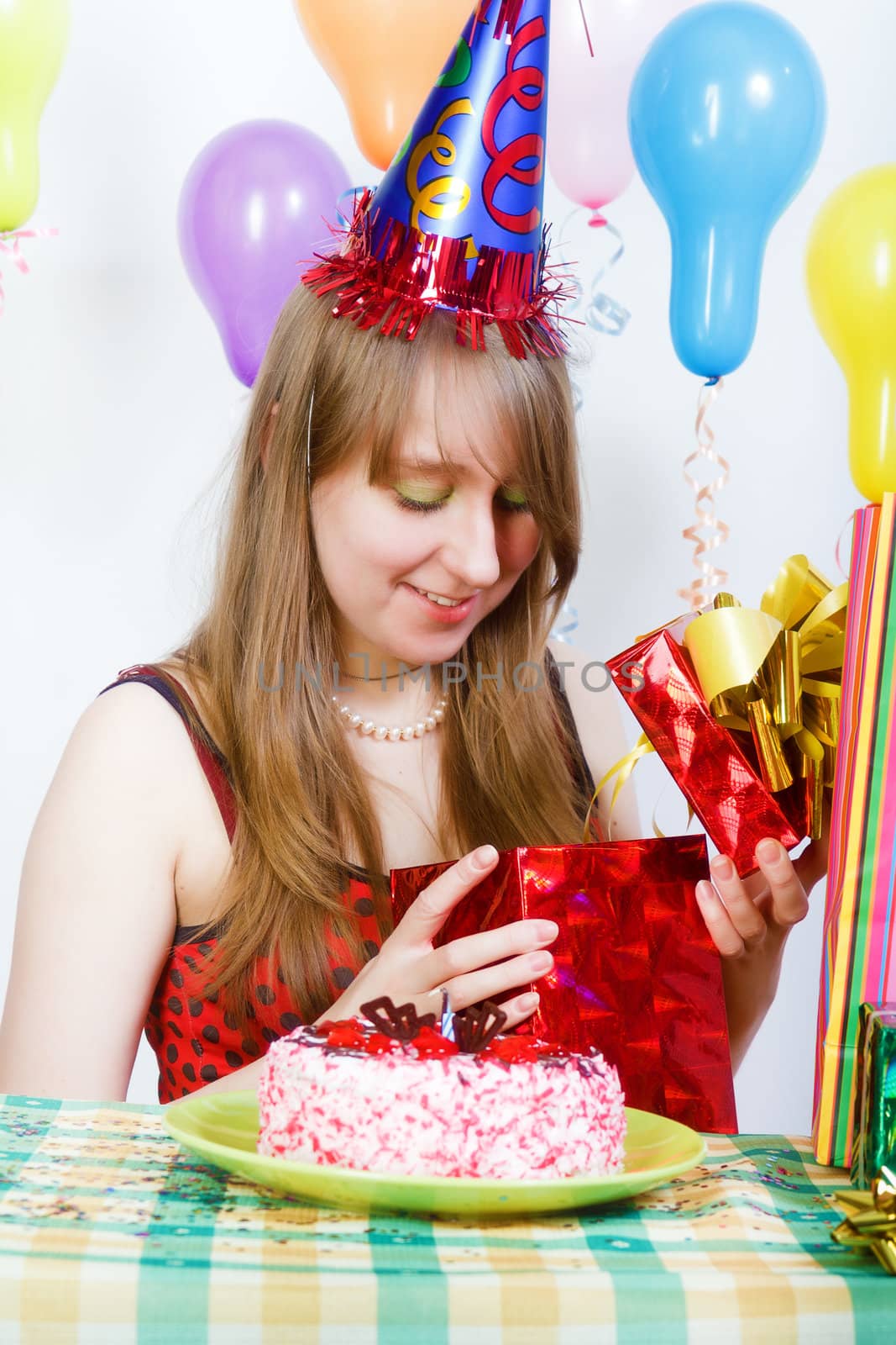 Birthday of a young girl. Opening the gifts