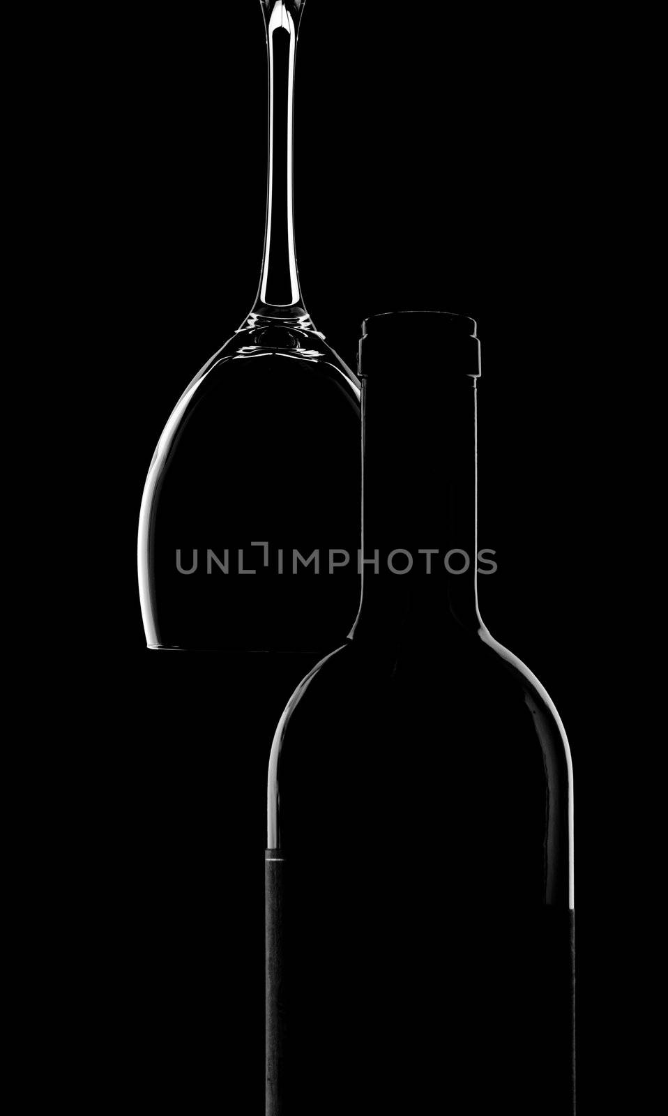 empty wine bottle and glass over black