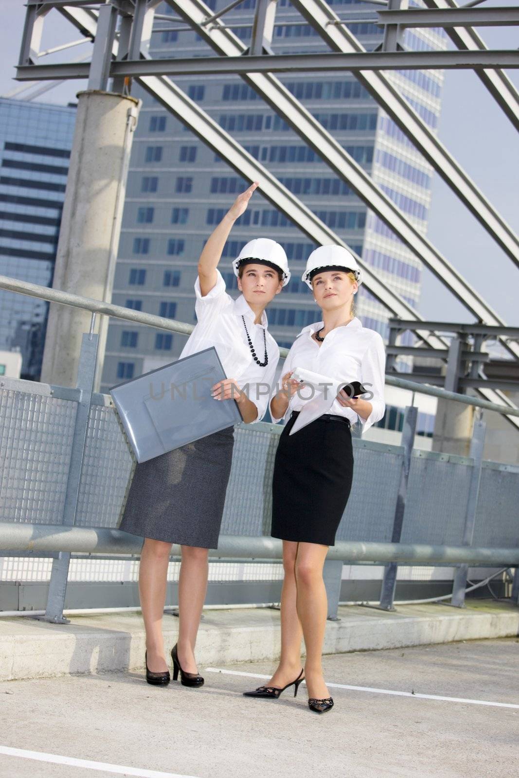 young female contractors in a front of building site