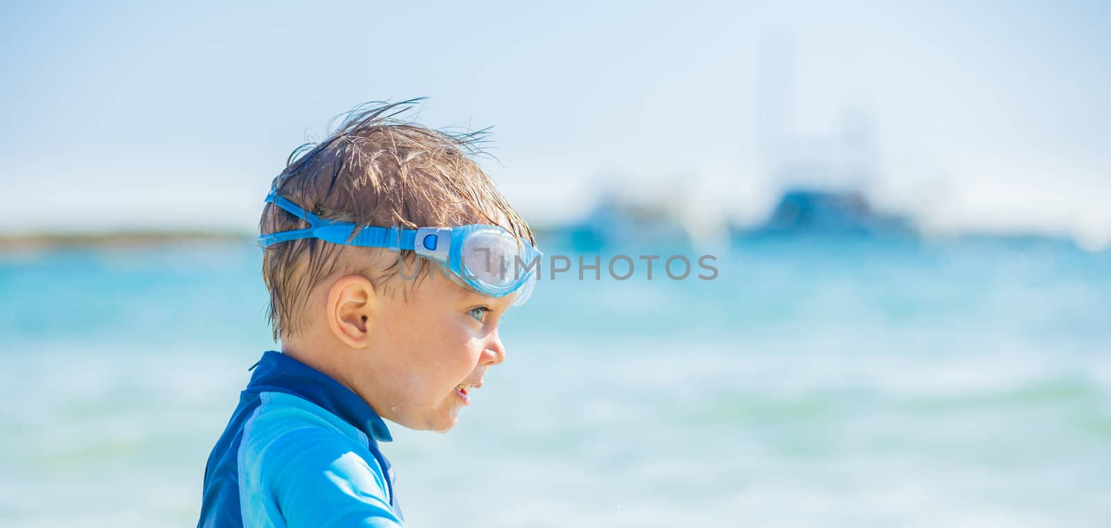 Portrait a cute little boy having fun on the exotic beach