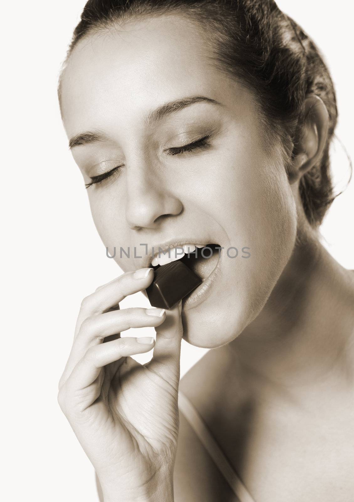 portrait of beautiful young woman eating chocolate