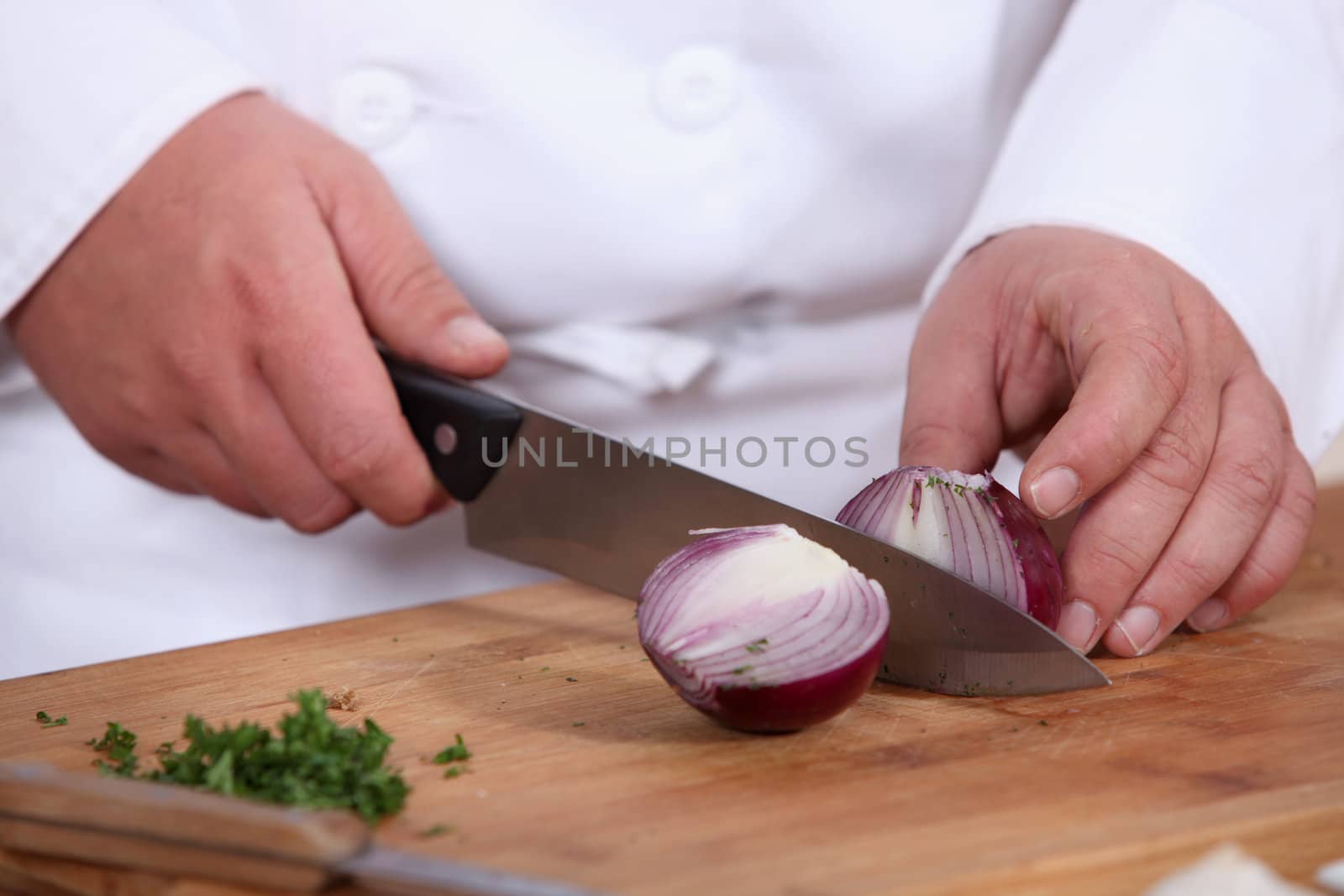 Chef chopping a red onion