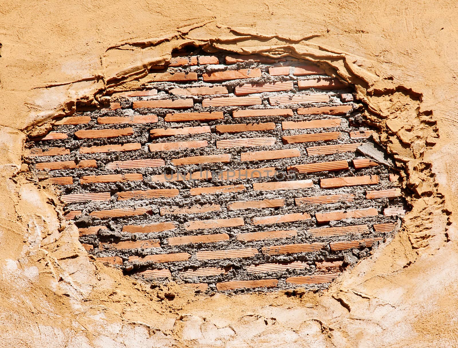 Brick wall with an old plaster as a background