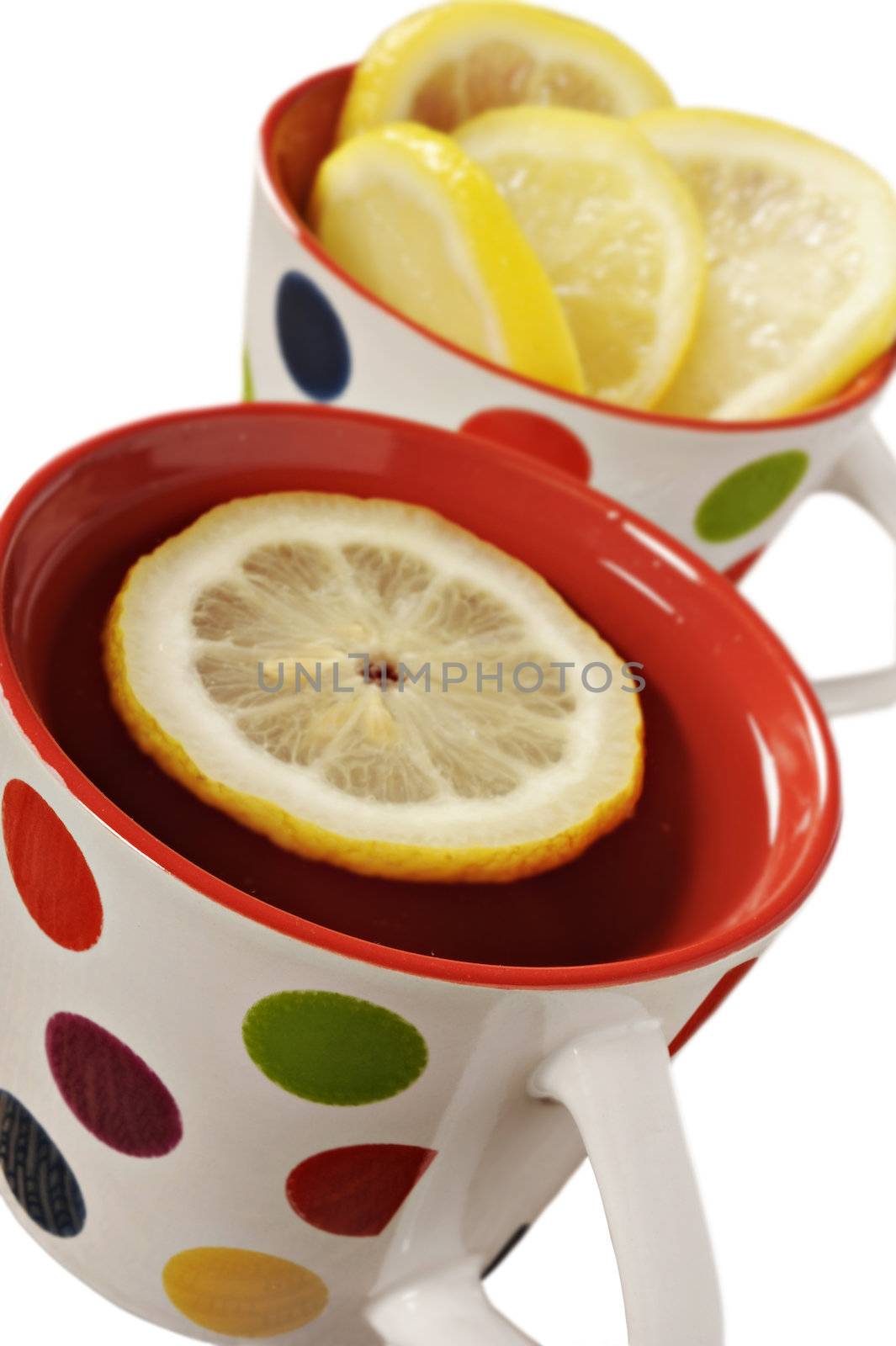 Healthy herbal tea with lemon in polka dot cups