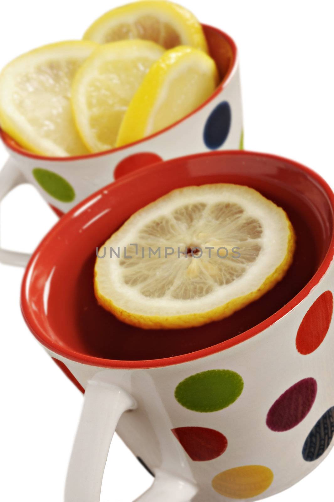 Healthy herbal tea with lemon in polka dot cups