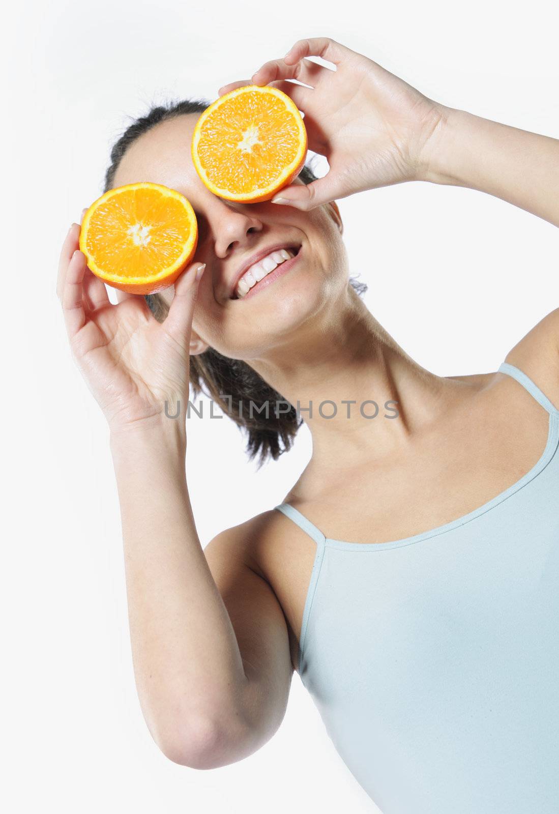 Funny girl portrait, holding oranges over eyes, diet concept