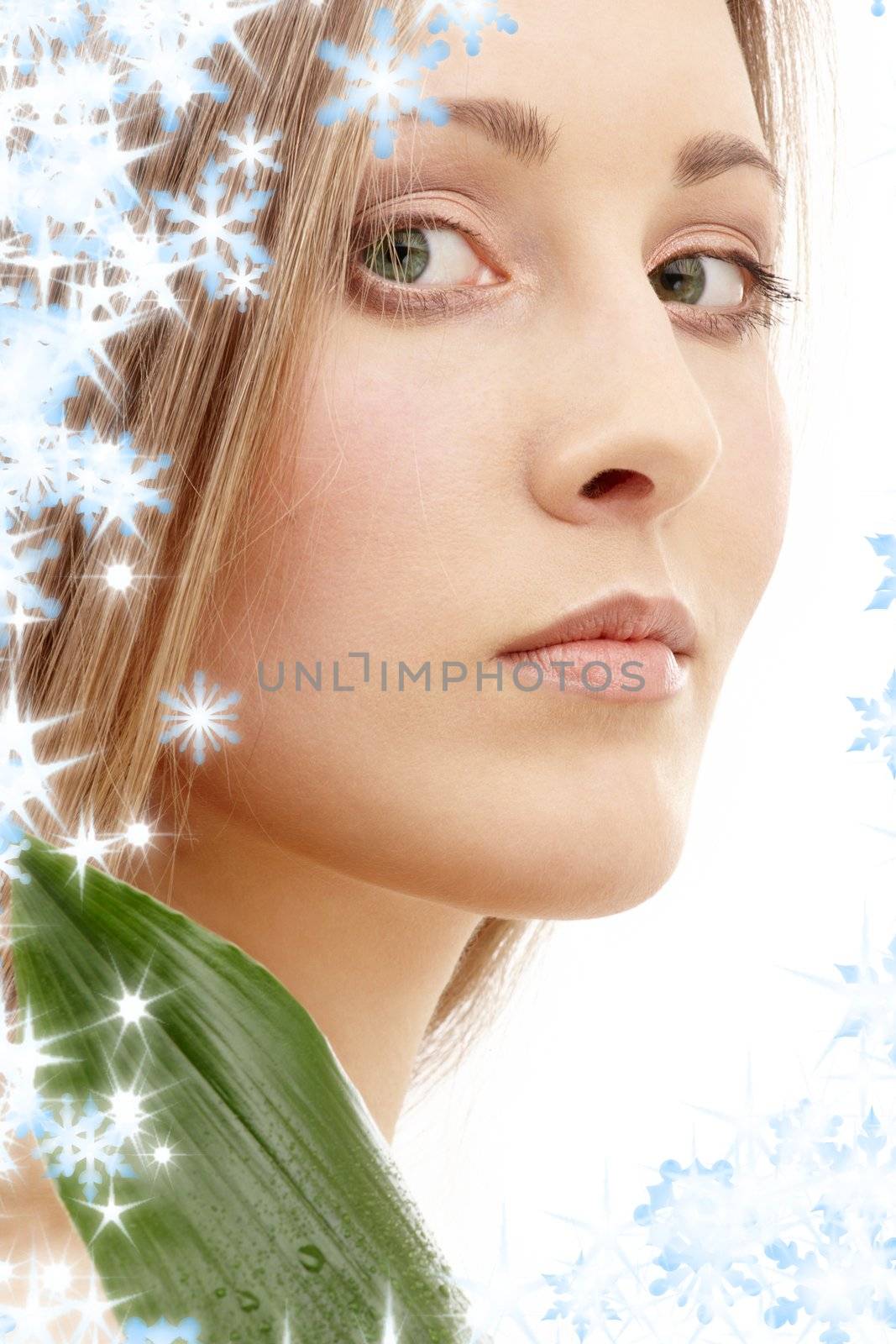 lovely woman with green leaf and snowflakes