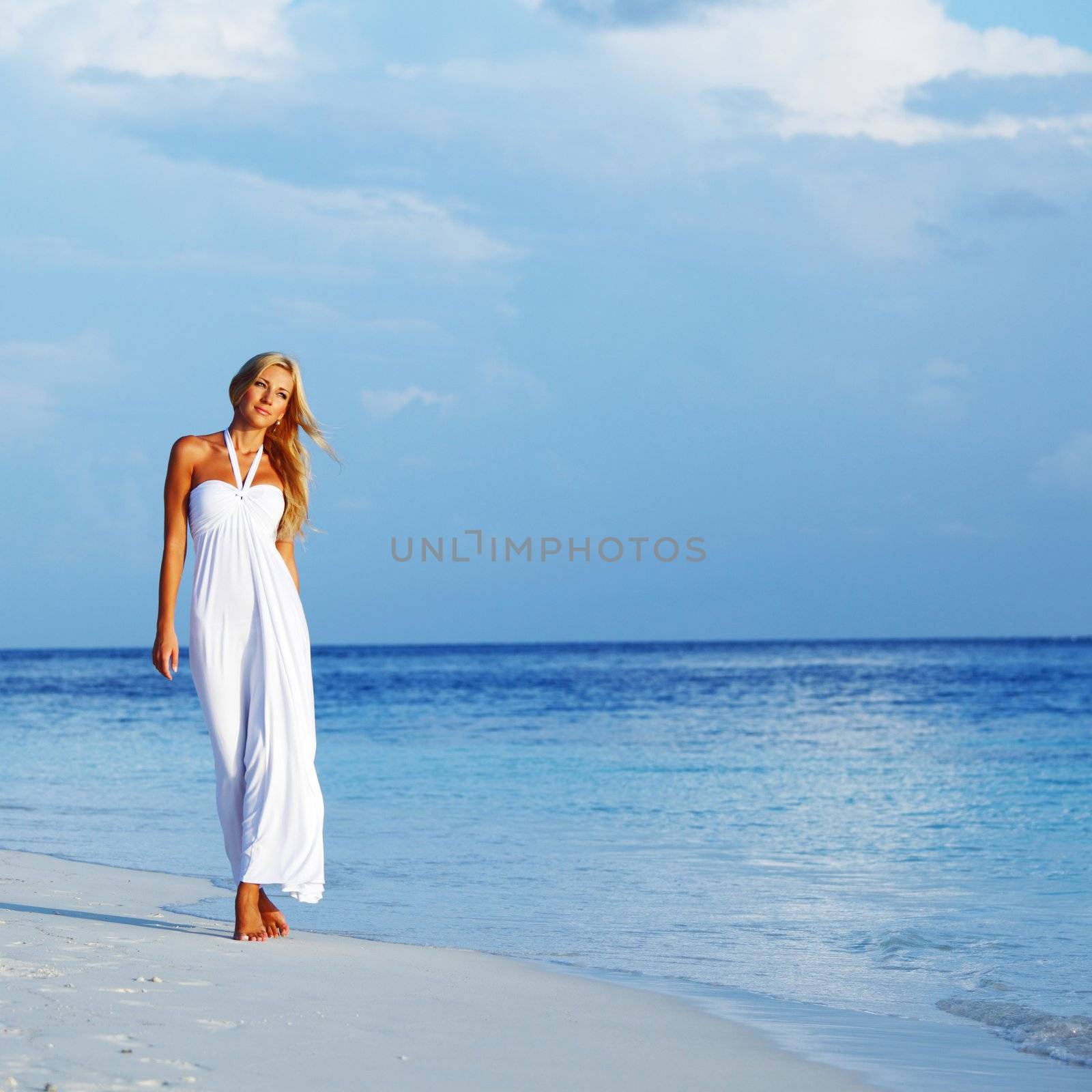 woman in a white dress on the ocean coast