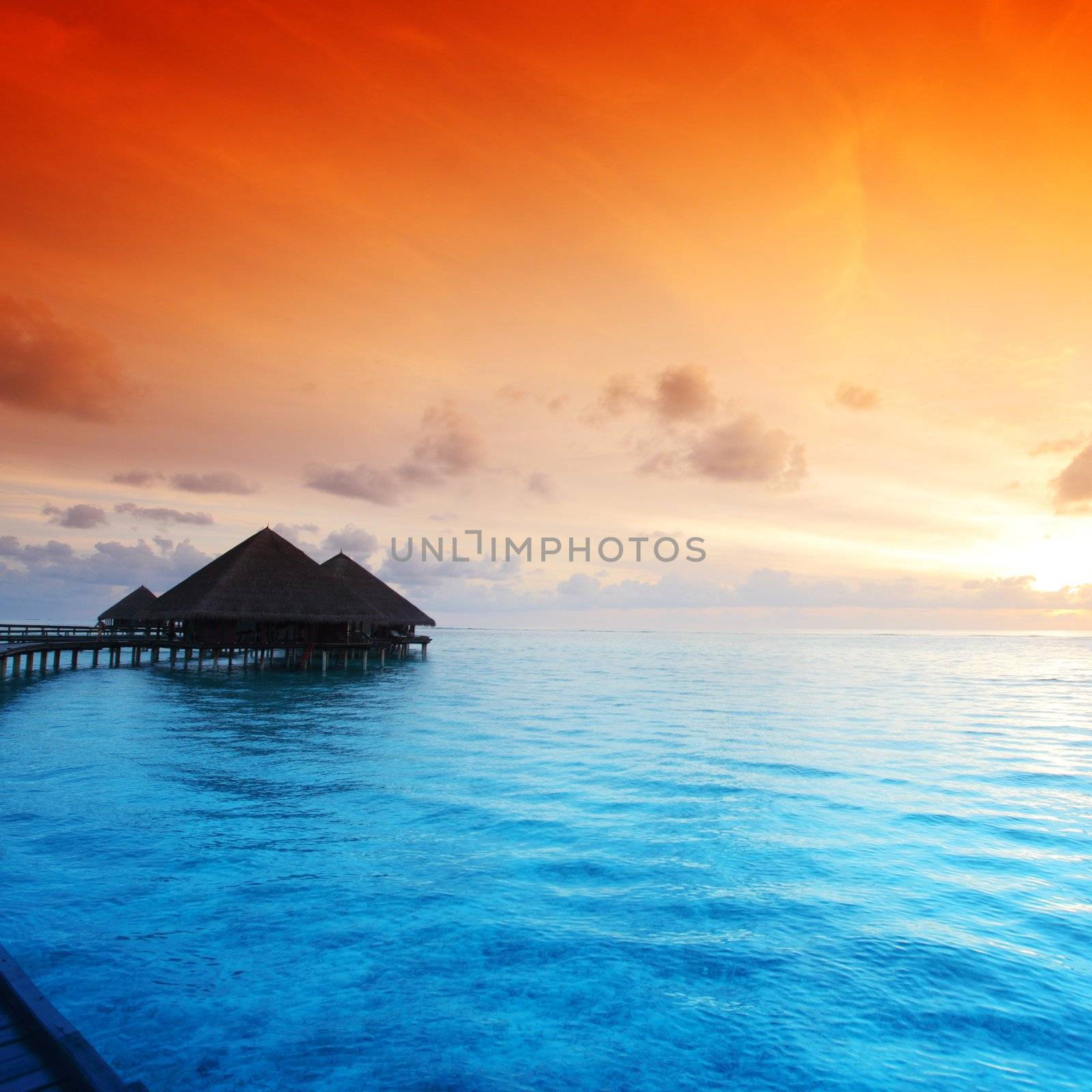 resort maldivian houses on sunrise