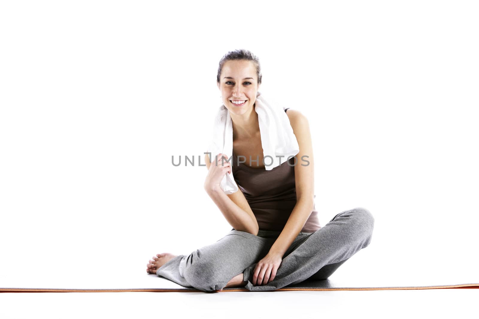 Young Woman In Fitness Clothing Resting After Exercise by stokkete