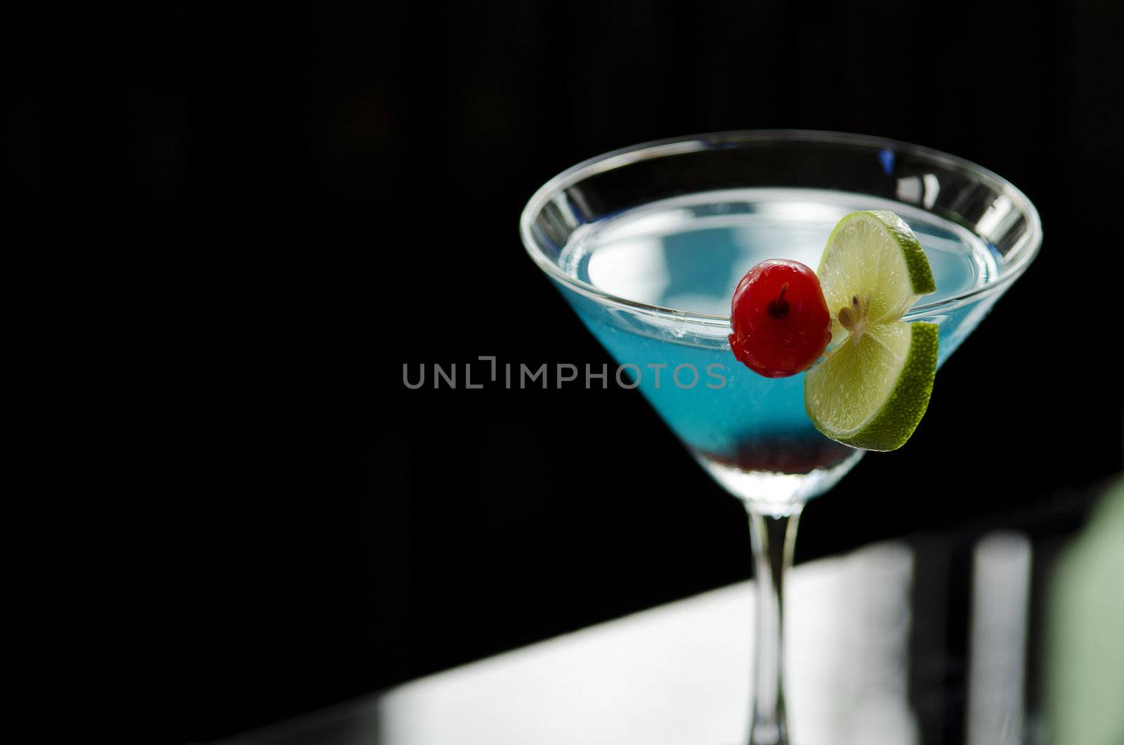 blue cocktail drink with cherry and lime by jackmalipan