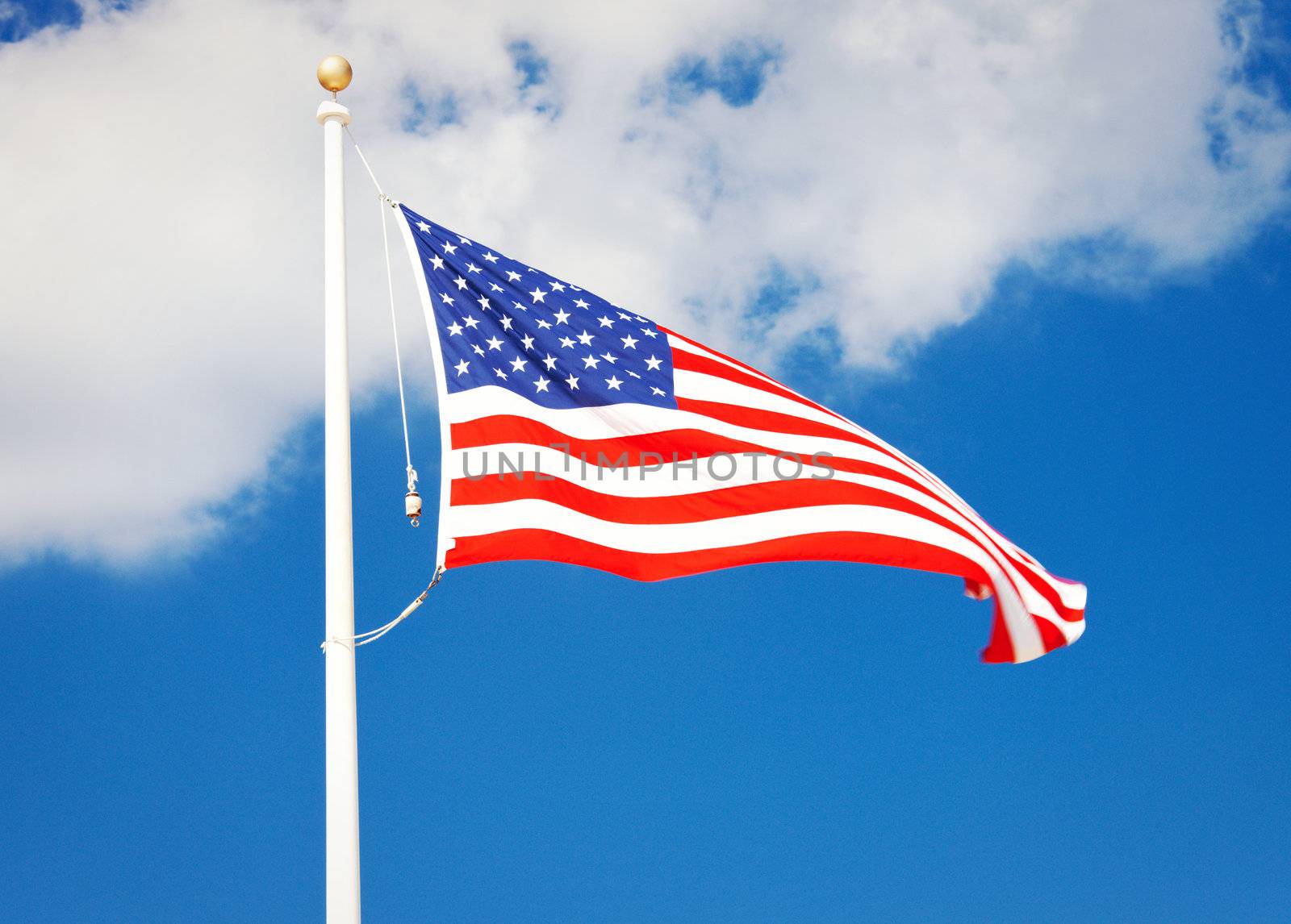 picture of the american flag flying in the wind