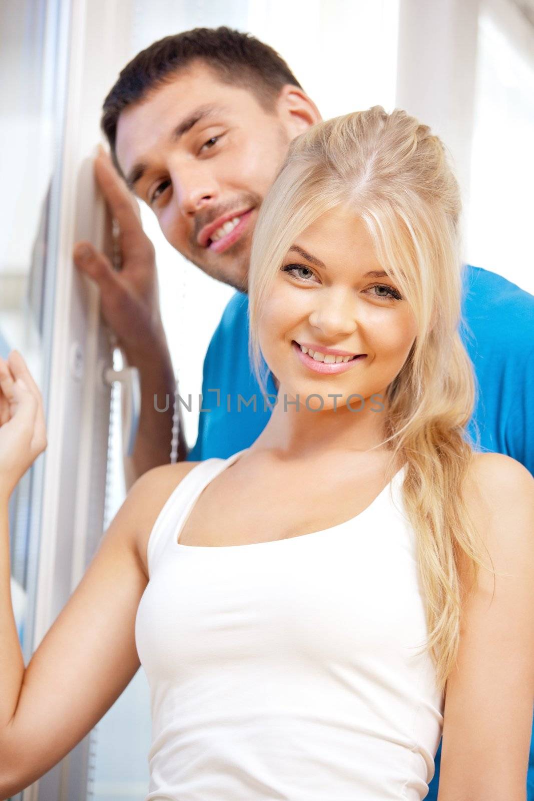 bright picture of happy couple at the window