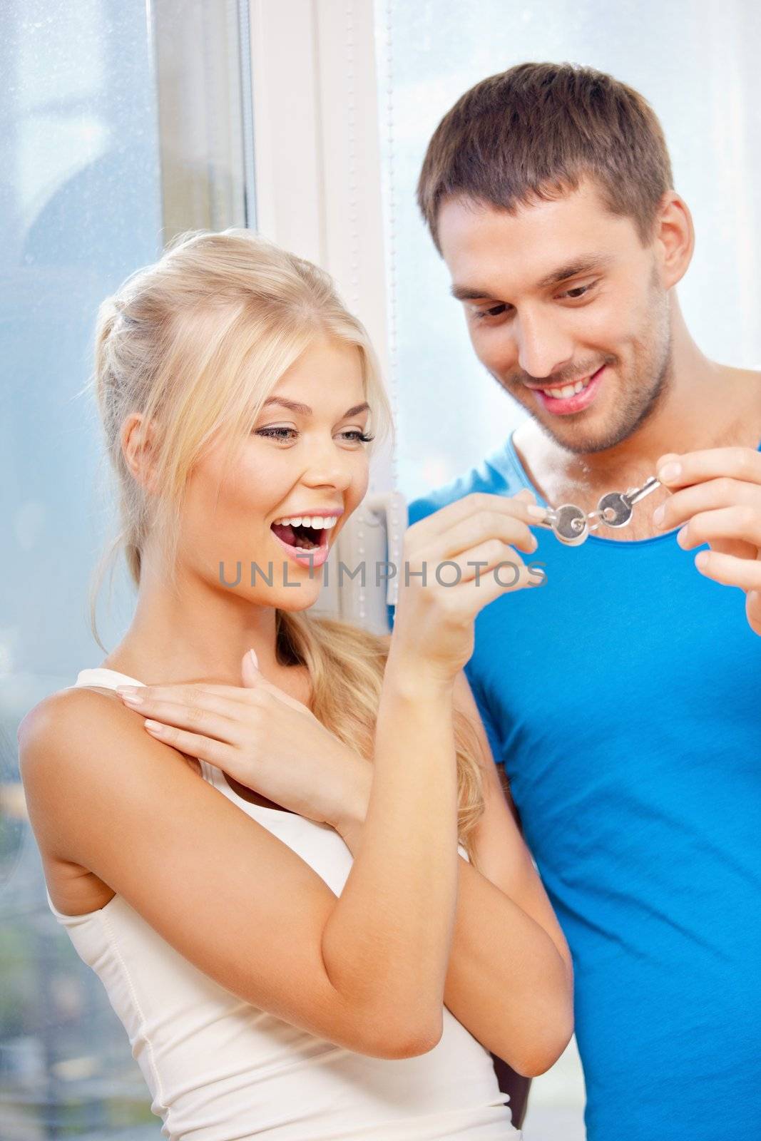 happy couple with keys by dolgachov