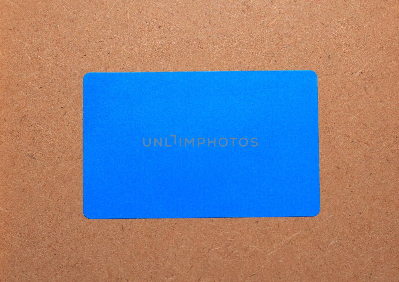Blue paper on a wooden background.Note paper.
