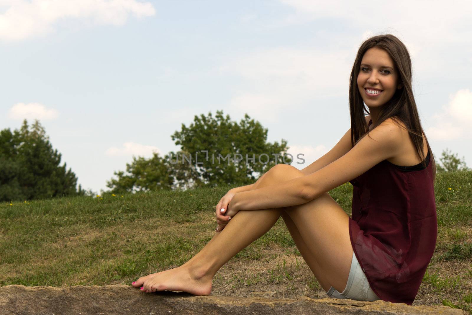 A pretty girl hangs out in the park.