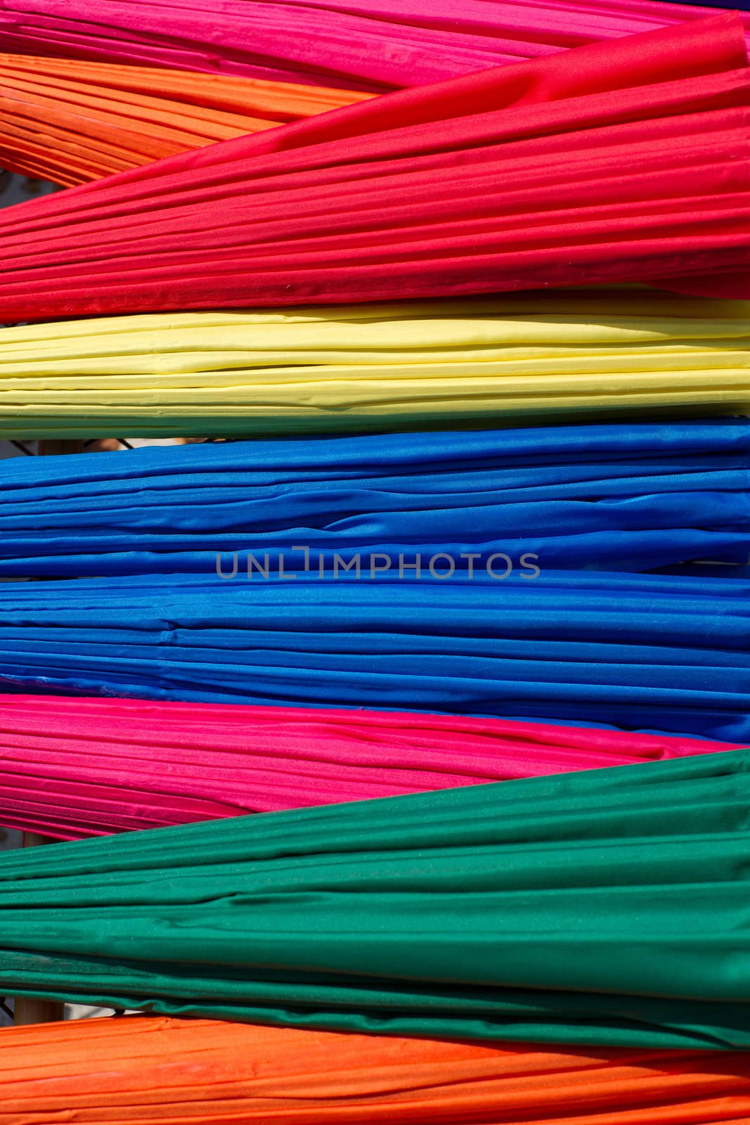 Background from closed multicolored umbrellas made in Bo Sang village, Chiang Mai province, Thailand