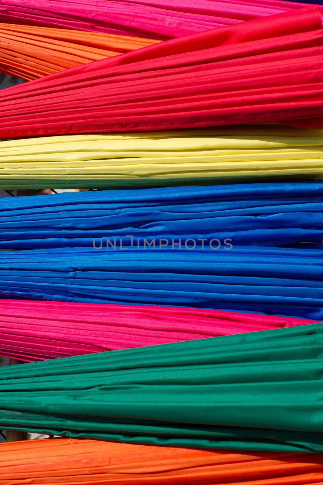 Background from closed multicolored umbrellas made in Bo Sang village, Chiang Mai province, Thailand