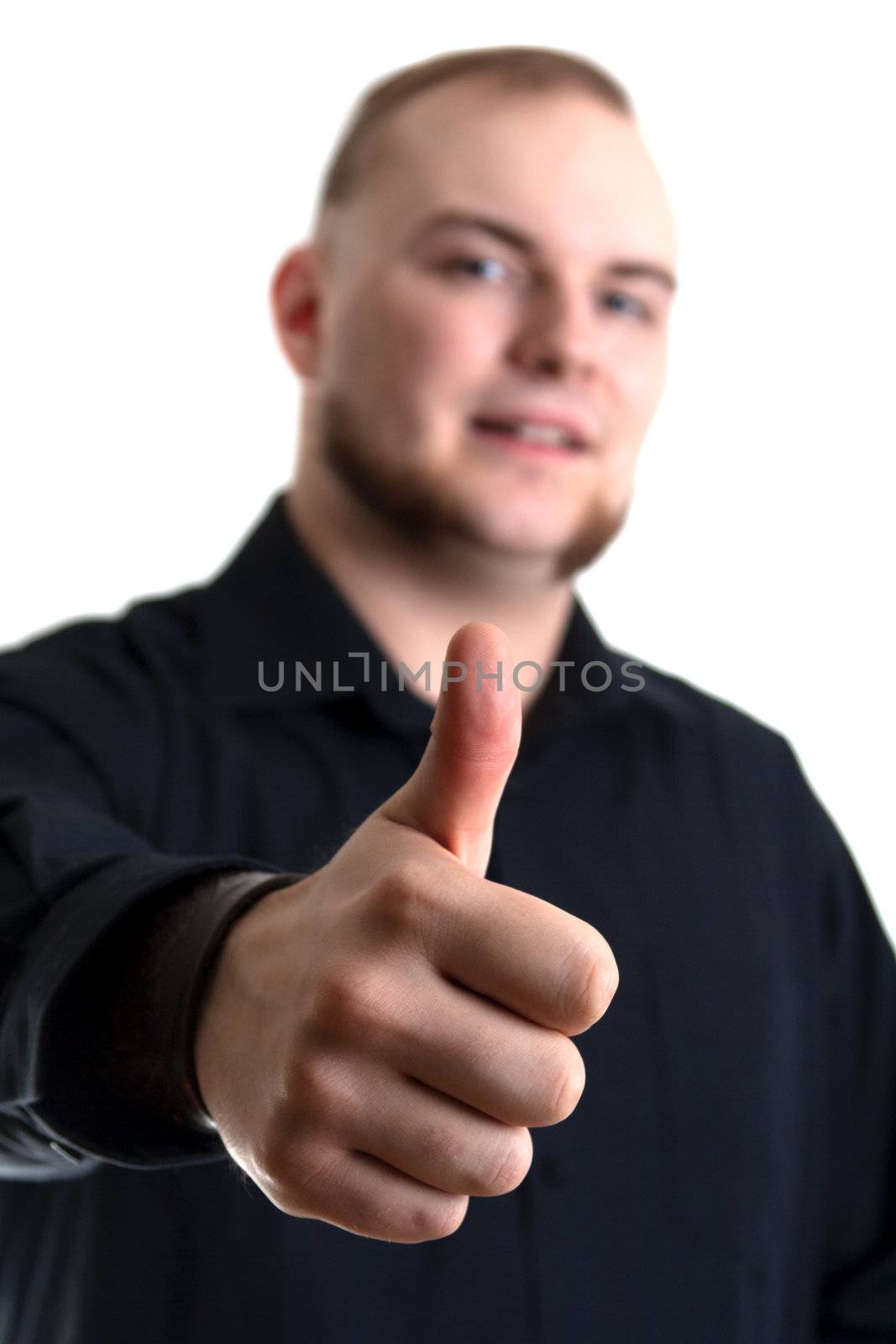 young man with blue eyes gives the thumbs up gesture on white background - Focus on his thumb 