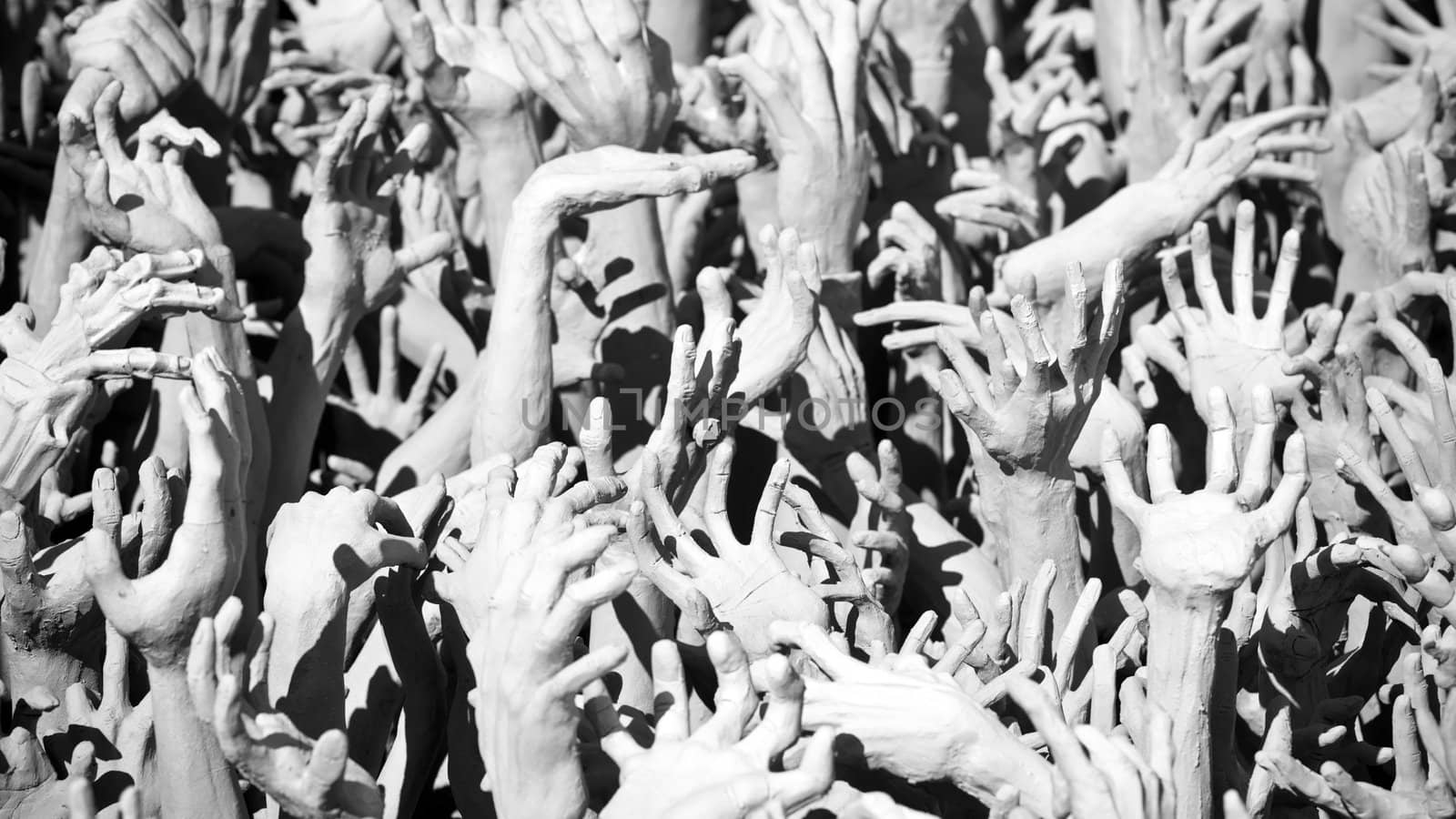 Hands statue from hell in Wat Rong Khun. Wat Rong Khun is a contemporary unconventional Buddhist temple in Chiang Rai, Chiangmai province, Thailand. It is designed in white color.