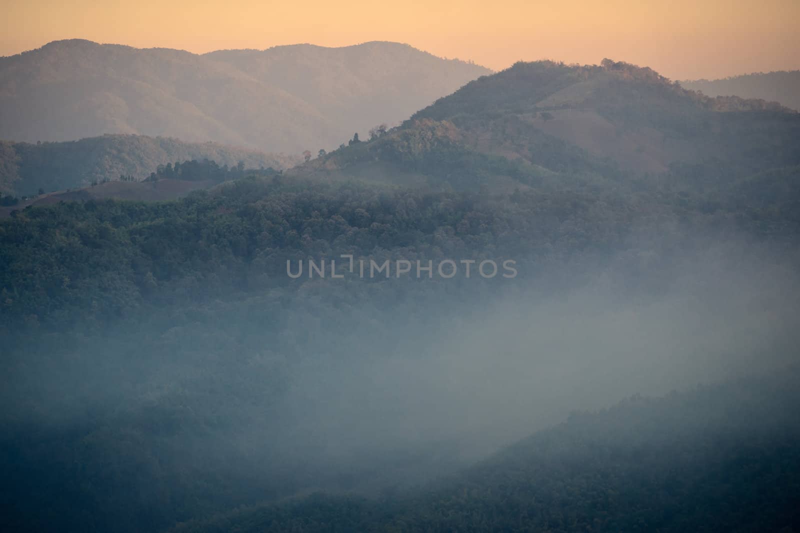 Mist in the mountains at sunset in northern Thailand
