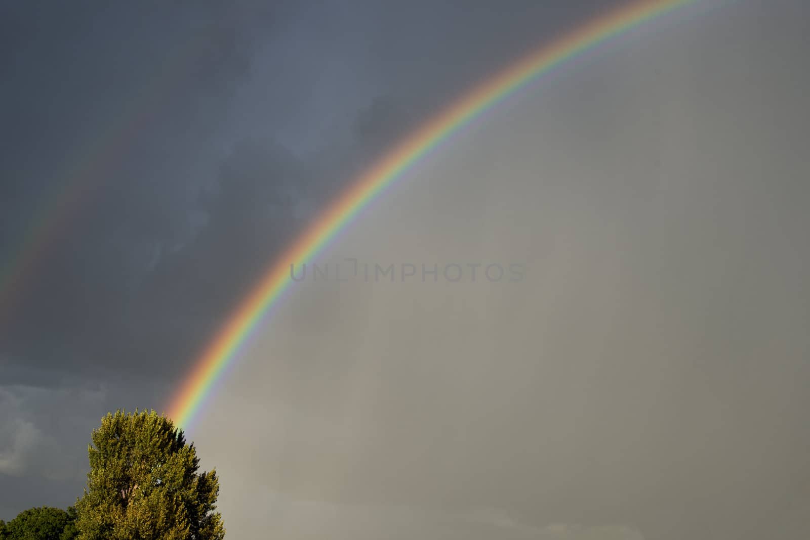 rainbow with dark clouds and bad weather