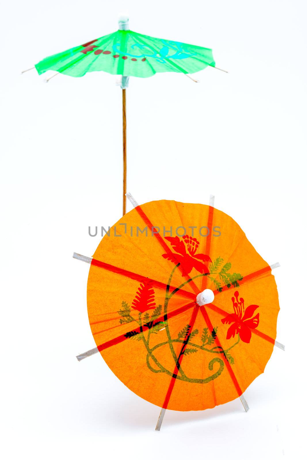 Two cocktail umbrellas on a white background