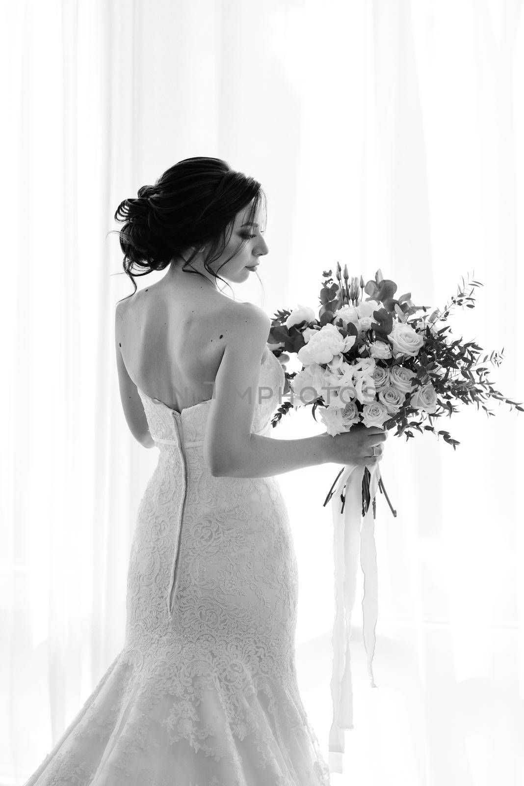 bride in a white dress with a bouquet by Andreua