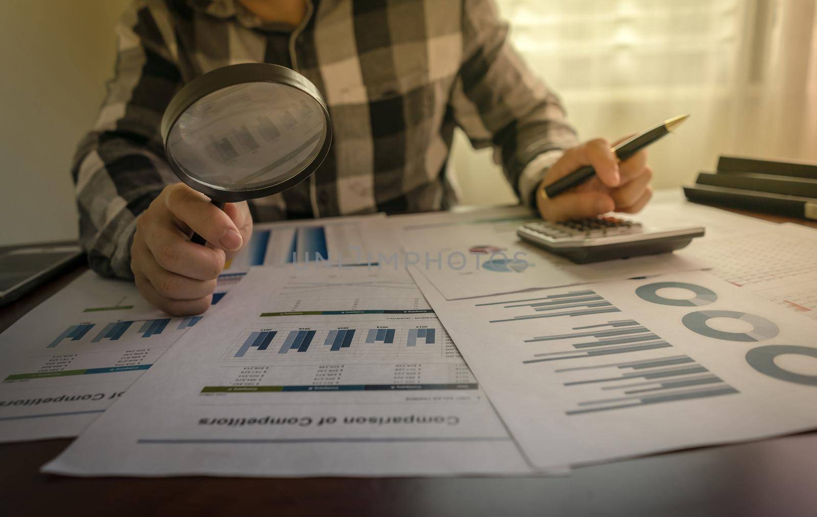 Audit Concept. Close-up Of Auditor checking financial statement, Internal audit, Auditing tax, Analyze return on investment with magnifying glass.