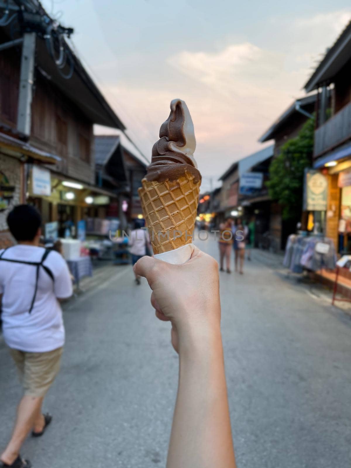 Female hand holding chocolate ice cream