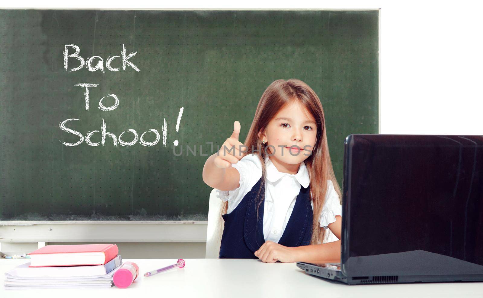 Happy and cute teen school girl sitting on laptop by Taut