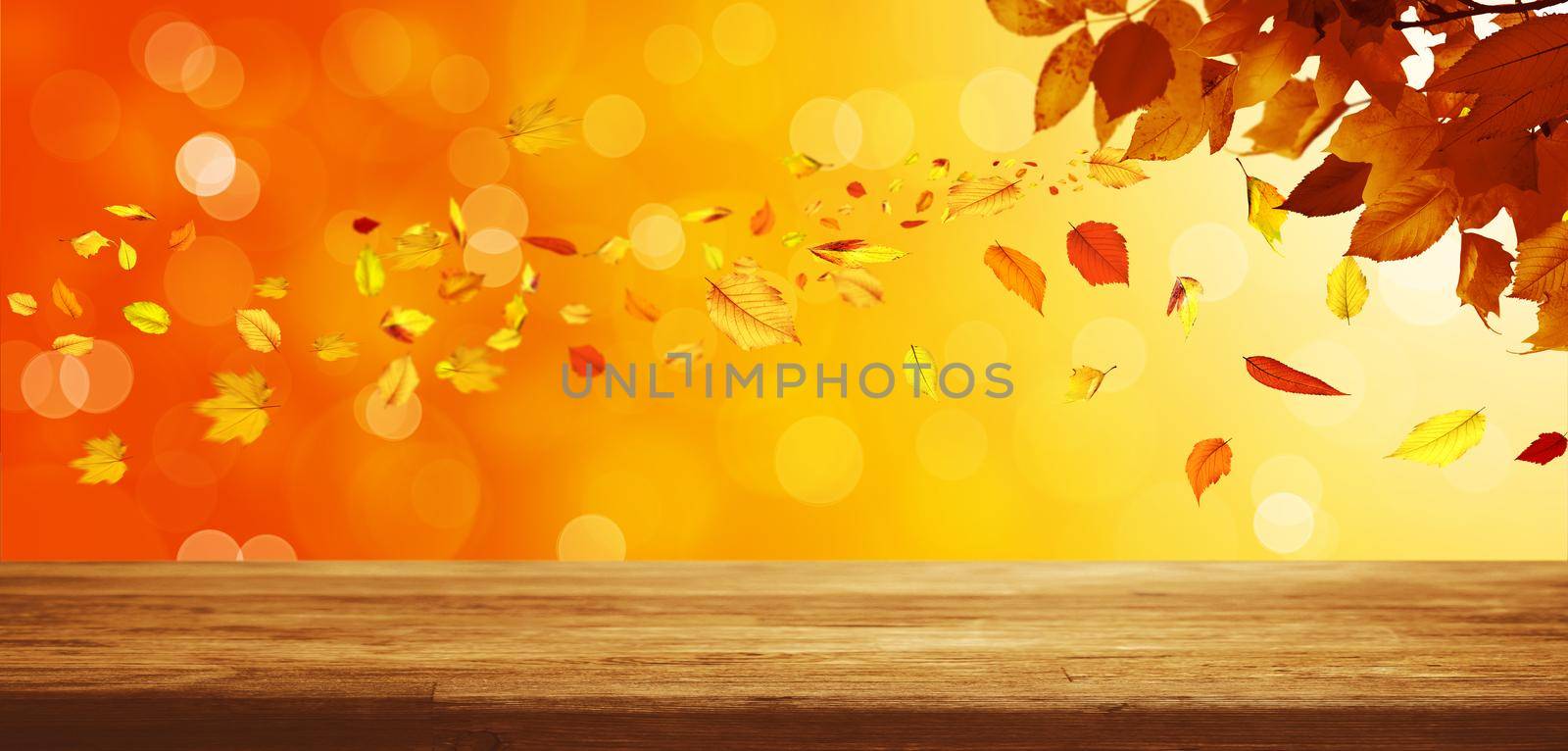 Colorful bright leaves falling on a wooden background by Taut