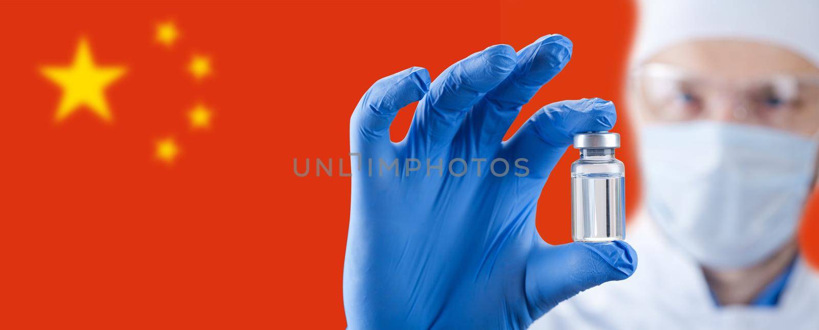Doctor holding a viol with vaccine against corona virus. Chinese flag on the background. by Taut