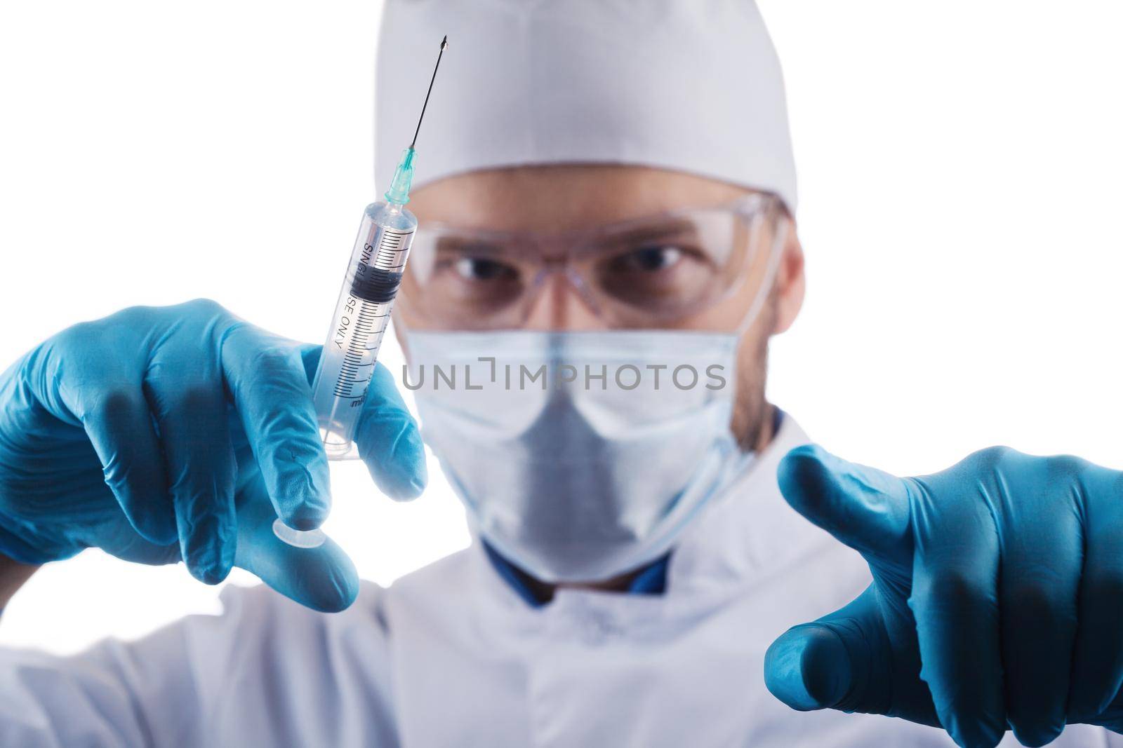Doctor holding a syringe with vaccine against corona virus. by Taut