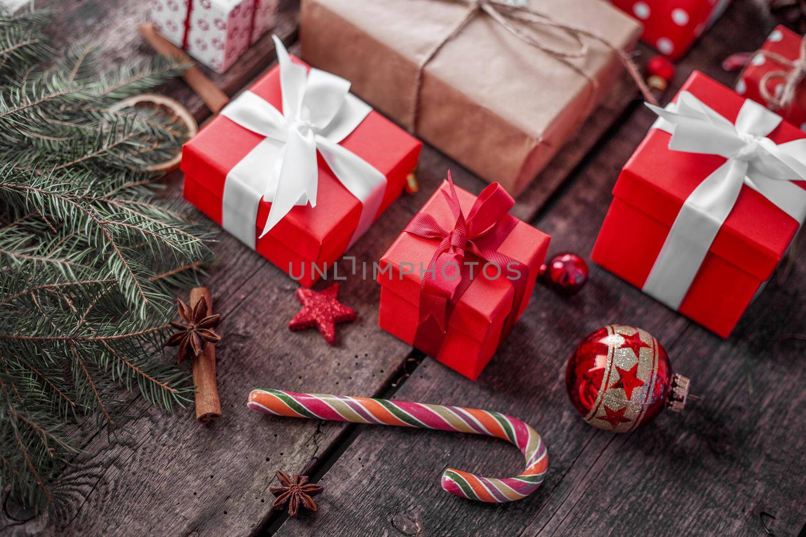 Gift box in wrapping paper with satin ribbon. Merry Christmas holiday concept.